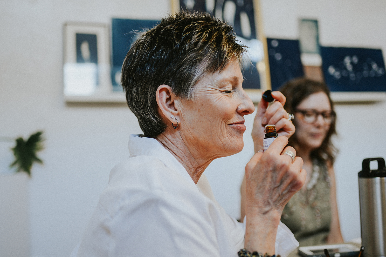 A woman inhales essential oils with enjoyment. 