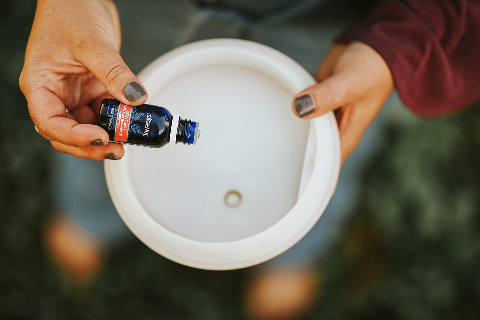 essential oil being dropped into a diffuser