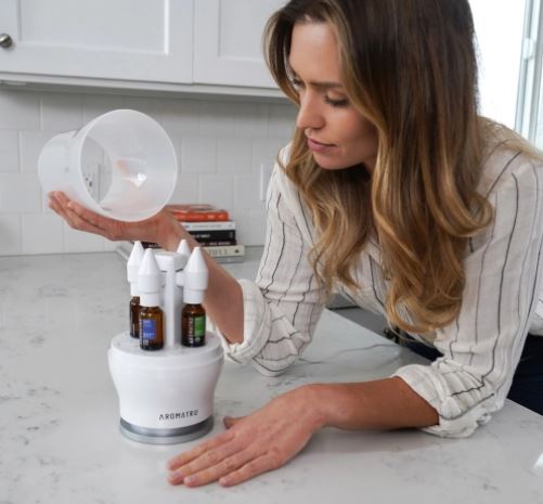 woman using her essential oil diffuser